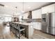 Bright kitchen with stainless steel appliances, spacious island with seating, stylish backsplash and open to the living area at 544 N Beville Ave, Indianapolis, IN 46201