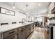 Modern kitchen with quartz countertop, kitchen island with sink and seating, and stainless steel appliances at 544 N Beville Ave, Indianapolis, IN 46201