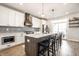 Modern kitchen featuring white cabinets, a large island with seating, and stylish backsplash at 544 N Beville Ave, Indianapolis, IN 46201
