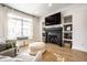 Bright living room with fireplace, shelving, large window, and comfortable seating at 544 N Beville Ave, Indianapolis, IN 46201