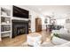 Modern living room featuring a sleek fireplace, built-in shelves, and hardwood floors at 544 N Beville Ave, Indianapolis, IN 46201