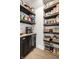 Walk-in pantry with dark wood shelves filled with organized food items, complementing the modern kitchen at 544 N Beville Ave, Indianapolis, IN 46201
