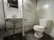 Small, bright bathroom with a vintage sink and toilet at 5450 E 18Th St, Indianapolis, IN 46218