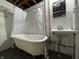 Vintage bathroom featuring a clawfoot tub and small sink at 5450 E 18Th St, Indianapolis, IN 46218