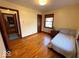 Bright bedroom with wood floors, a comfortable bed, and abundant natural light at 5450 E 18Th St, Indianapolis, IN 46218