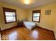 Bright bedroom with wood floors, a comfortable bed, and large windows at 5450 E 18Th St, Indianapolis, IN 46218