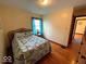Cozy bedroom featuring hardwood floors, a comfortable bed, and bright natural light at 5450 E 18Th St, Indianapolis, IN 46218