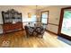 Dining room with a glass-top table, four chairs, and lots of natural light from a window at 5450 E 18Th St, Indianapolis, IN 46218