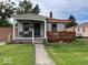 Charming single-story home featuring a covered porch, wood deck, and cozy curb appeal at 5450 E 18Th St, Indianapolis, IN 46218