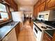 Traditional kitchen featuring wood cabinets, green countertops, and stainless steel appliances at 5450 E 18Th St, Indianapolis, IN 46218