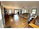 Open living area with wood floors, neutral furniture, and a view to the dining space at 5450 E 18Th St, Indianapolis, IN 46218