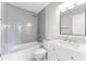 Modern bathroom with gray tiled shower, white vanity, and contemporary fixtures at 5548 Painted Maple Ct, Indianapolis, IN 46254