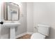 Stylish powder room featuring a pedestal sink and modern fixtures at 5548 Painted Maple Ct, Indianapolis, IN 46254