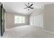 Spacious bedroom with neutral walls, carpet, vaulted ceiling, and sliding barn door at 5548 Painted Maple Ct, Indianapolis, IN 46254