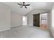 Large bedroom featuring carpet, vaulted ceiling, barn door, and access to ensuite bath at 5548 Painted Maple Ct, Indianapolis, IN 46254