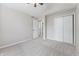 Bedroom with carpet, ceiling fan, closet, and doorway to other rooms at 5548 Painted Maple Ct, Indianapolis, IN 46254