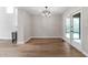Bright dining area with hardwood floors, modern chandelier, and french doors leading to the outdoors at 5548 Painted Maple Ct, Indianapolis, IN 46254