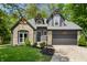 Charming home featuring stone accents, gray siding, and a well-manicured front yard at 5548 Painted Maple Ct, Indianapolis, IN 46254