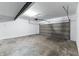 The home's empty two-car garage featuring a concrete floor and a modern metal door at 5548 Painted Maple Ct, Indianapolis, IN 46254