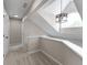 Upstairs hallway with hardwood floors and modern chandelier at 5548 Painted Maple Ct, Indianapolis, IN 46254