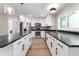 Modern kitchen featuring white cabinets, black countertops, and stainless steel appliances at 5548 Painted Maple Ct, Indianapolis, IN 46254