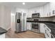 Well-equipped kitchen with stainless steel appliances and black granite countertops at 5548 Painted Maple Ct, Indianapolis, IN 46254