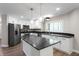 Modern kitchen with white cabinets, dark countertops and stainless steel appliances at 5548 Painted Maple Ct, Indianapolis, IN 46254