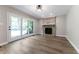 Bright living room featuring a stone fireplace and sliding glass doors leading to the outdoors at 5548 Painted Maple Ct, Indianapolis, IN 46254
