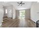Bright living room with hardwood floors, vaulted ceilings, and large windows at 5548 Painted Maple Ct, Indianapolis, IN 46254