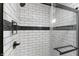 Contemporary shower with white subway tile, black accent tile, and glass enclosure at 5548 Painted Maple Ct, Indianapolis, IN 46254