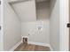 Utility area with washer/dryer hookups, light-colored walls, and wood-look flooring at 5548 Painted Maple Ct, Indianapolis, IN 46254