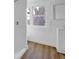 A bathroom with hardwood floors, a shower on the left and a sink under a window that looks onto a tree at 555 S Auburn St, Indianapolis, IN 46241