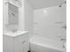 All-white bathroom with tub and shower combo, modern vanity and fixtures at 555 S Auburn St, Indianapolis, IN 46241