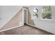 Well lit bedroom with dual windows, carpet, and painted accent wall at 555 S Auburn St, Indianapolis, IN 46241