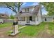 Charming renovated home with a vibrant yellow front door, landscaping, and a well-maintained lawn at 555 S Auburn St, Indianapolis, IN 46241