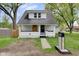 Charming renovated home with a vibrant yellow front door and freshly painted white exterior at 555 S Auburn St, Indianapolis, IN 46241