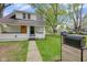 Charming renovated home with a vibrant yellow front door, landscaping, and a well-maintained lawn at 555 S Auburn St, Indianapolis, IN 46241
