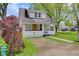 Charming renovated home with a vibrant yellow front door, landscaping, and a well-maintained lawn at 555 S Auburn St, Indianapolis, IN 46241