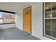 Inviting front porch with a bright yellow door and a welcoming 