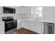 Modern kitchen featuring stainless steel appliances, white cabinets, and light countertops at 555 S Auburn St, Indianapolis, IN 46241