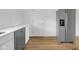 This kitchen features stainless steel appliances, white cabinets and light countertops at 555 S Auburn St, Indianapolis, IN 46241
