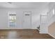 Bright living room with wood floors, fresh paint, new staircase, and a large window at 555 S Auburn St, Indianapolis, IN 46241