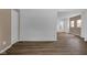 Bright, empty living room with wood floors, fresh paint, and a new interior door at 555 S Auburn St, Indianapolis, IN 46241