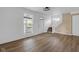 Bright living room with wood floors, fresh paint, a staircase, and a large window at 555 S Auburn St, Indianapolis, IN 46241