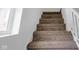 Carpeted stairway with white wood trim and window at 555 S Auburn St, Indianapolis, IN 46241