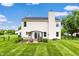 Relaxing backyard features a covered patio area, fire pit, lush lawn, and mature landscaping for outdoor living at 5617 Gainesway Dr, Greenwood, IN 46142