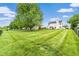 Large, well-maintained backyard features a play set and ample green space, ideal for Gathering activities and outdoor fun at 5617 Gainesway Dr, Greenwood, IN 46142