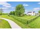 Spacious backyard with mature trees, play set, and lush lawn offers a private and serene outdoor retreat at 5617 Gainesway Dr, Greenwood, IN 46142