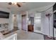 Bedroom with light-colored walls, hardwood floors, a ceiling fan and a closet with frosted-glass doors at 5617 Gainesway Dr, Greenwood, IN 46142