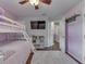Bedroom with a bunk bed, ceiling fan, flat screen TV and an open closet with shelves and storage at 5617 Gainesway Dr, Greenwood, IN 46142